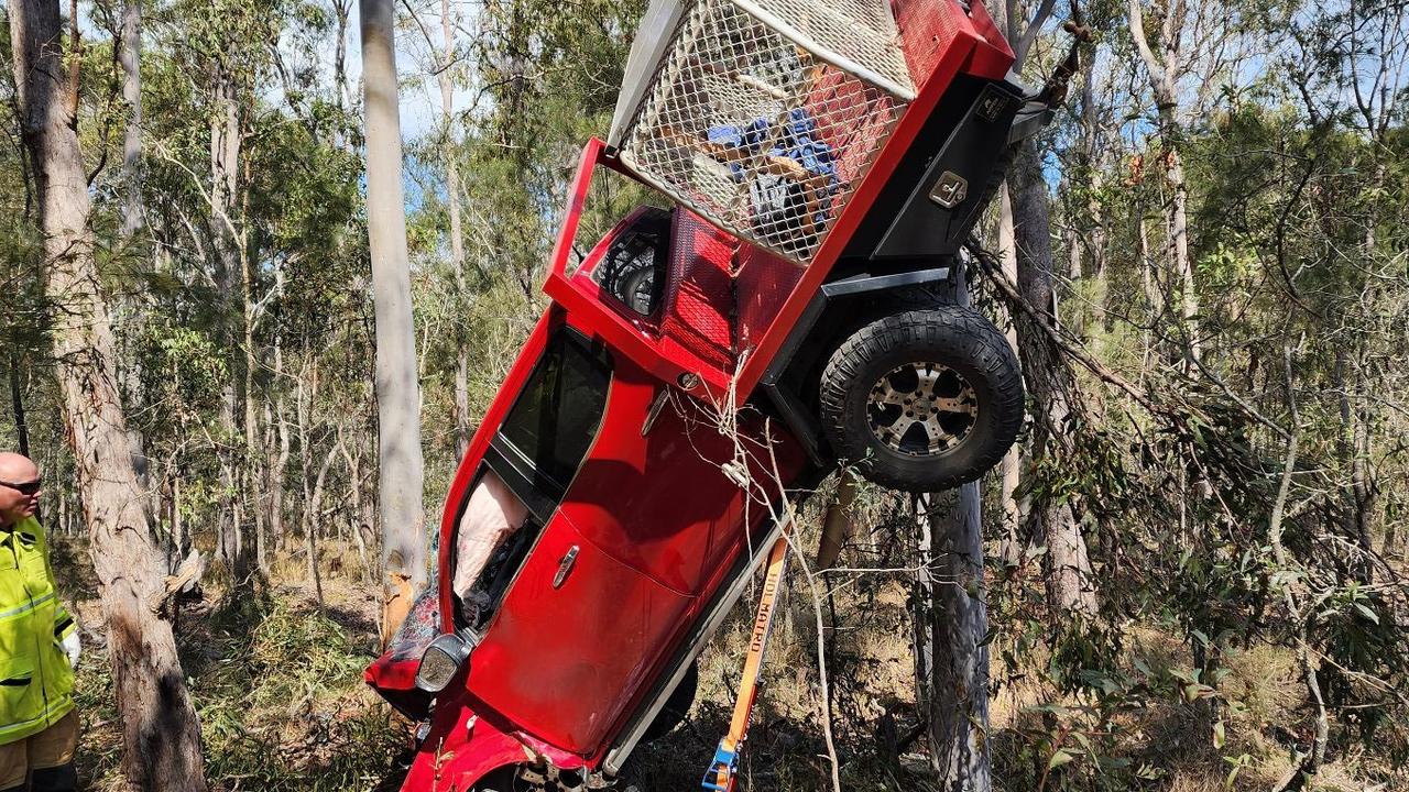 One person was airlifted in a critical condition from the scene of a dramatic crash north of Gympie where a ute was left suspended in trees . Picture: Clayton's Towing