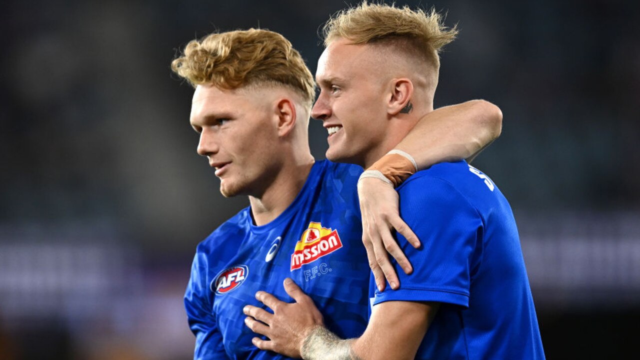 MELBOURNE, AUSTRALIA - APRIL 15: Adam Treloar of the Bulldogs and Jaidyn Stephenson of the Kangaroos hug before the round five AFL match between the North Melbourne Kangaroos and the Western Bulldogs at Marvel Stadium on April 15, 2022 in Melbourne, Australia. (Photo by Quinn Rooney/Getty Images)