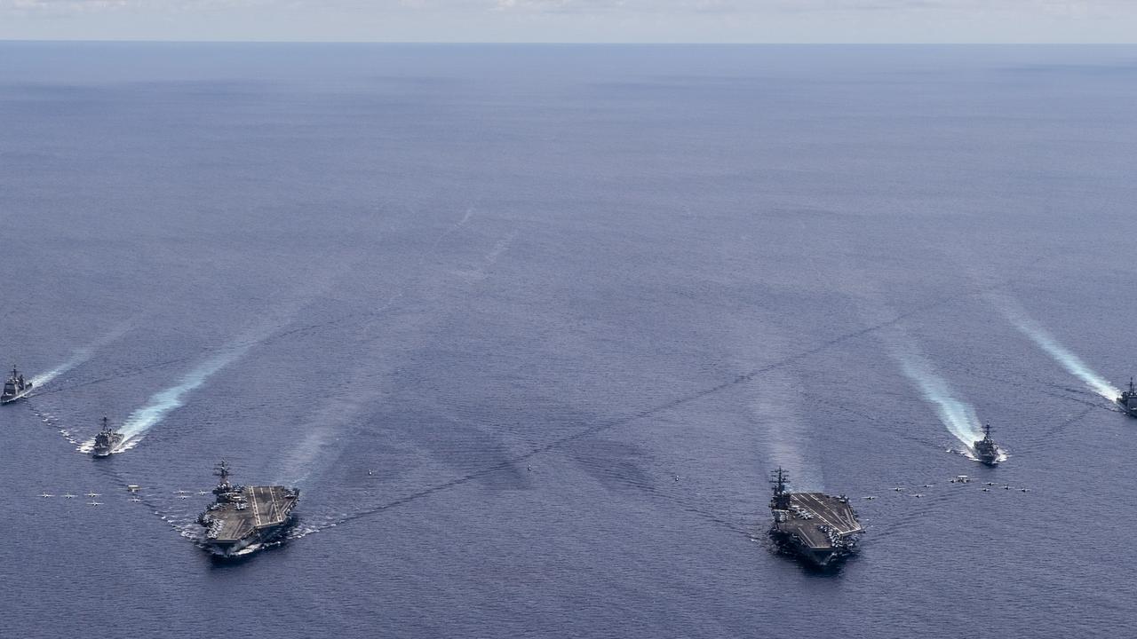 Aircraft from Carrier Air Wing 5 and Carrier Air Wing 17 fly in formation over the Nimitz Carrier Strike Force in the South China Sea on July 6. Picture: US Navy/Mass Communication Specialist 3rd Class Keenan Daniels