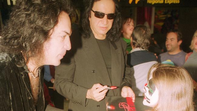 Fans get up close and personal with Paul Stanley and Gene Simmons from KISS at Melbourne Airport in 2003.