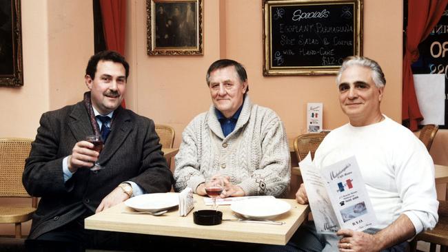 Mario Condello (left) and fellow underworld figure Graham Kinniburgh (centre) celebrate at a restaurant.