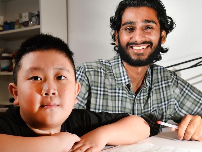 Michael Chang, 5, with tutor Prabhiot Singh. Picture: John Gass