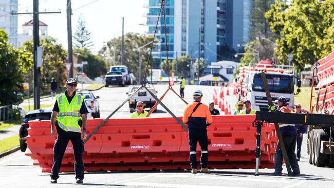 Police observe workers setting up barriers in Dixon Street, Coolangatta. Picture: Nigel Hallett