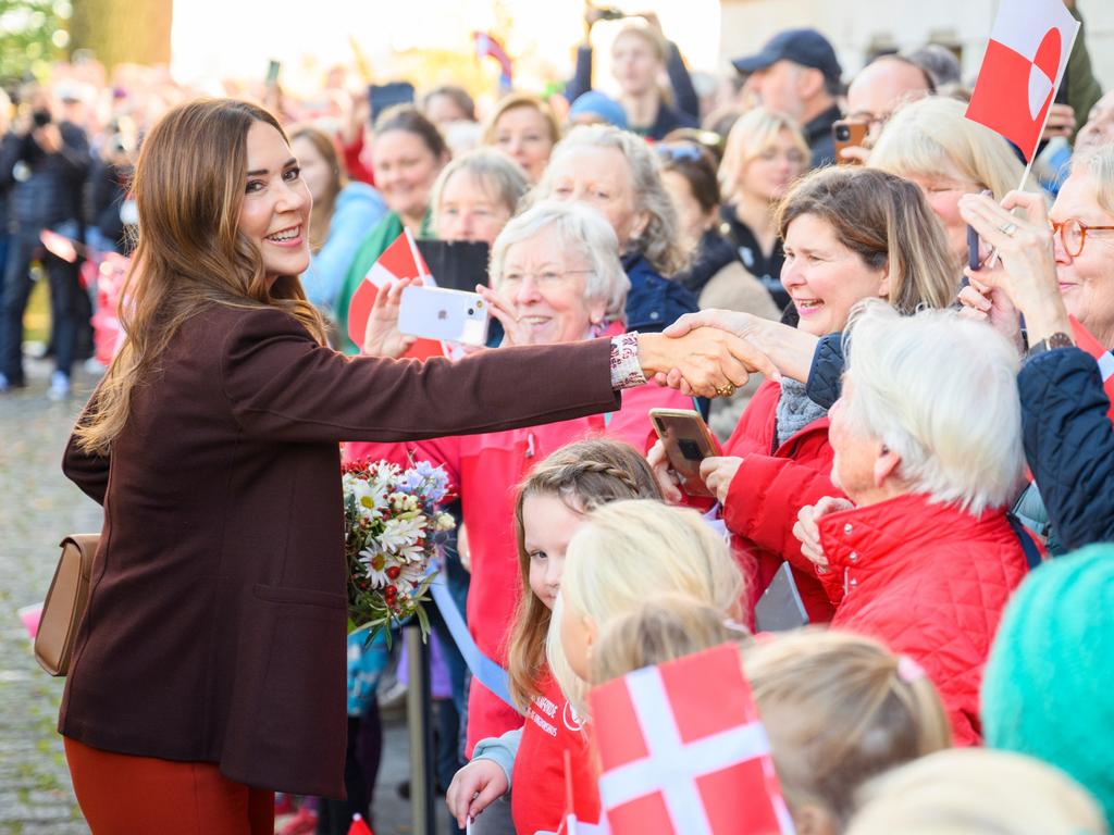 Queen Mary of Denmark shakes the hands of well wishers during a royal visit to Germany. Picture: Gregor Fischer/Getty Images