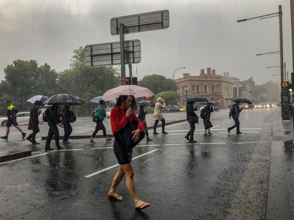 7am - Commuters struggle against torrential rain and gale force winds in Newtown as Sydney is lashed with a monumental early summer storm, 28/11/18. Photo: Nicholas Eager