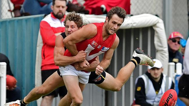 Glenelg's Matt Snook tackles North's Jarred Allmond. Picture: Tom Huntley