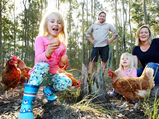 17/05/2017: (L-R) Mia, 5, Simon Carroll, 37, Asta, 3, and wife Kelly Eaton, 35, at Little Hill Farm in Mount Vincent on Wednesday. They are part of a growing movement of small-scale farmers who consider themselves a section of the food business rather than the agriculture industry. They are the New Farmers who work through nearly every phase of the business: breeding, animal husbandry, processing, marketing and distribution. It's a rural subculture for those who question their foodÕs back-story or simply want to eat better. Hollie Adams/The Australian