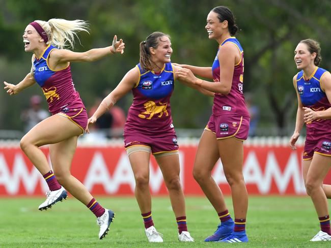 Orla O'Dwyer (left) of the Lions celebrates kicking a goal with teammates during the Round 1 AFLW match against the Crows at Hickey Park in Brisbane. Picture: AAP IMAGE/DARREN ENGLAND