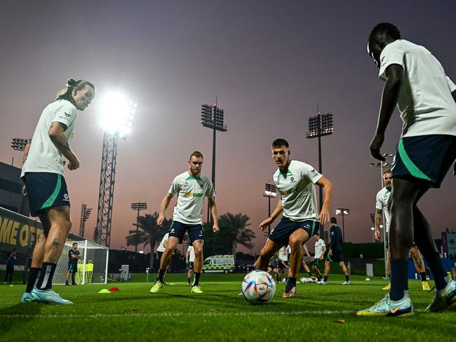 Australia's midfielder #10 Ajdin Hrustic (2R), Australia's midfielder #03 Nathaniel Atkinson (2L) and teammates attend a training session at the Aspire Academy in Doha. Picture: Chandan Khanna/AFP