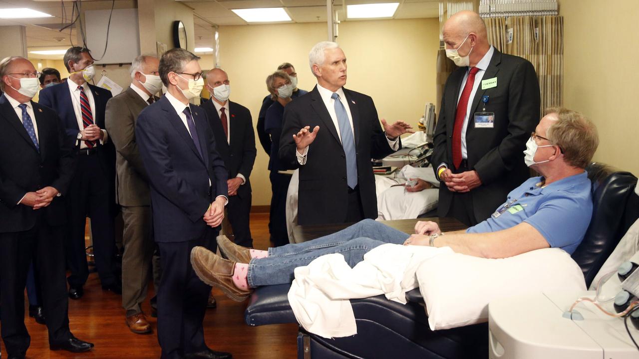 Vice President Mike Pence, centre without a mask, meets staff and a COVID-19 patient at the famous Mayo Clinic on Tuesday Picture: Jim Mone