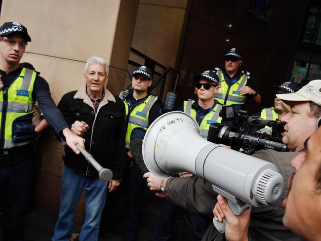 A large number of police separate the two groups. Picture: Jake Nowakowski