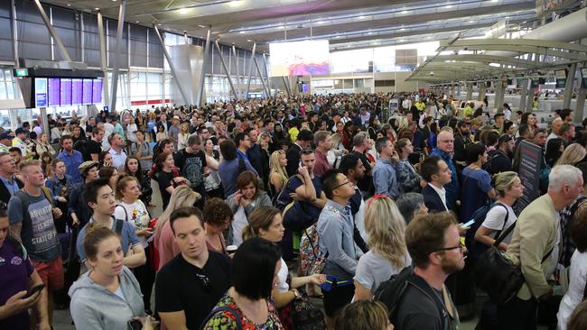 Chaos ... Stranded travellers wait for news at T2 Terminal. Picture: John Grainger