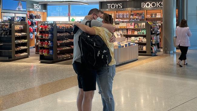 Lincoln Mathews embraces his wife Maxine after arriving from Sydney on Monday morning. Picture: Felicity Ripper