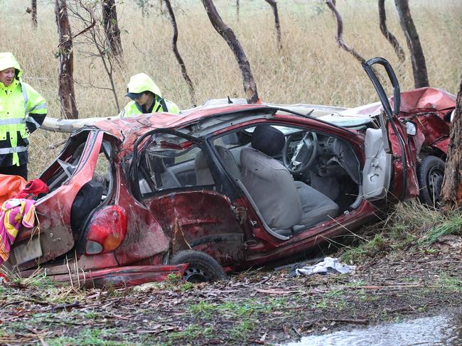 Police remove the wreckage from the scene. Picture: David Crosling