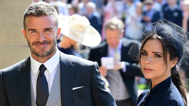Former England footballer David Beckham (L) and fashion designer Victoria Beckham (R) arrive for the wedding ceremony of Britain's Prince Harry, Duke of Sussex and US actress Meghan Markle at St George's Chapel, Windsor Castle, in Windsor, on May 19, 2018. / AFP PHOTO / POOL / Ian West