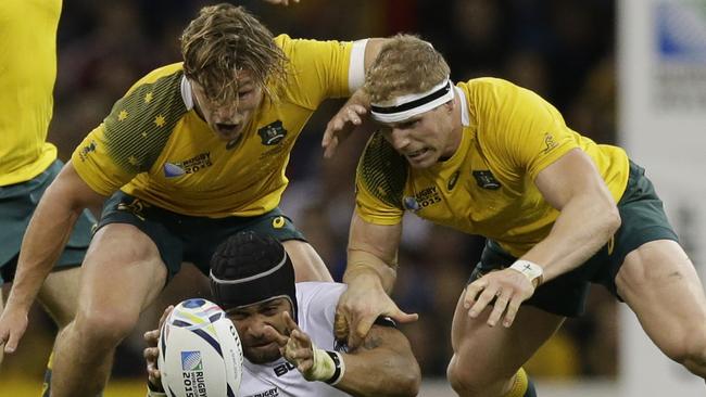 Fiji's Netani Talei is tackled by Australia's David Pocock, right, and Michael Hooper during the Rugby World Cup Pool A match between Australia and Fiji at the Millennium Stadium, Cardiff, Wednesday, Sept. 23, 2015. (AP Photo/Matt Dunham)