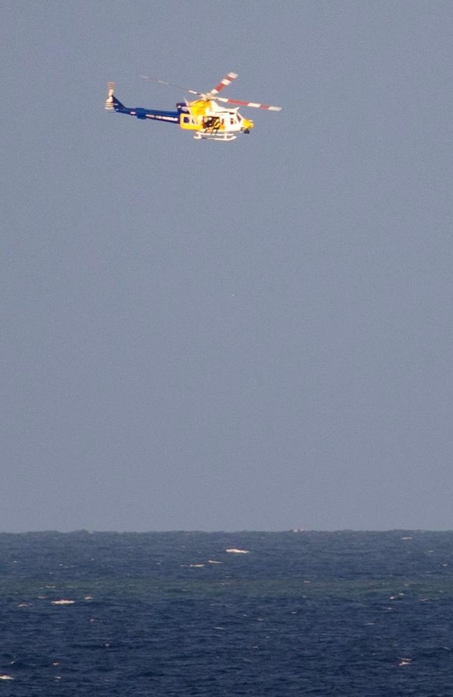 The dramatic rescue as seen from Dolphin Heads. Ryan Taylor, 33, and brothers Sean and Mitch Cook had spent Friday fishing near an island off Mackay'&#128;&#153;s coast and were returning with a hefty haul in the Esky when their boat experienced '&#128;&#156;fuel drama'&#128;&#157;. Picture: Louise Smith