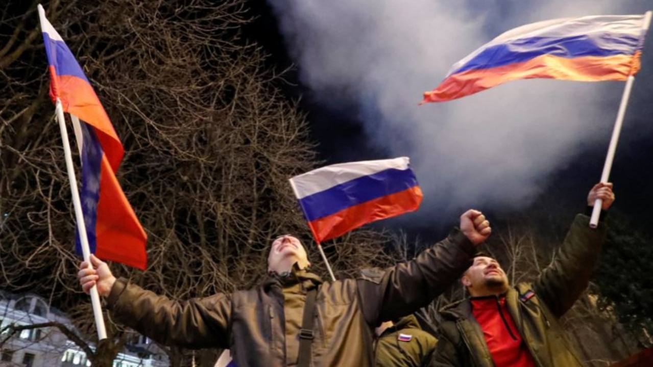Stage-managed demonstrations of supporters waving Russian flags sprang up in Donetsk as Putin’s troops rolled in on Monday night. Picture: Reuters