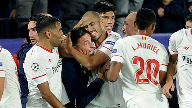 Sevilla's Argentinian midfielder Guido Pizarro (R) celebrates with Sevilla's Argentinian coach Eduardo Berizzo (L) after scoring.