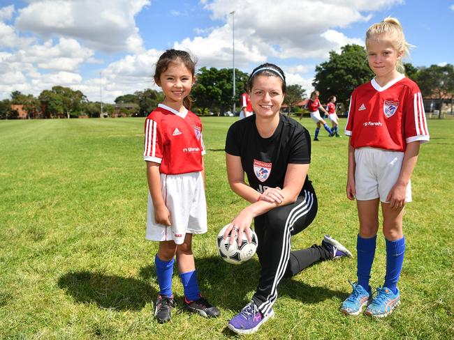 Pagewood Botany Football Club members Erin Jones, Coach Julia Chernoukha and Annabelle Pollett pose for a photo at Jellicoe Park in Pagewood, Sydney, Saturday, Nov. 11, 2017. (AAP Image/Joel Carrett)