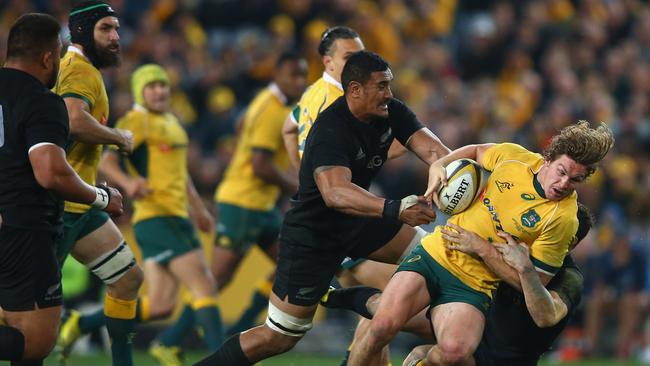 SYDNEY, AUSTRALIA - AUGUST 08: Michael Hooper of the Wallabies is tackled during The Rugby Championship match between the Australia Wallabies and the New Zealand All Blacks at ANZ Stadium on August 8, 2015 in Sydney, Australia. (Photo by Mark Kolbe/Getty Images)