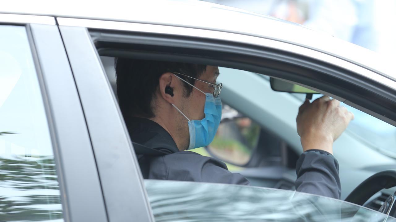 A man drives out of an aged care facility in Sydney where an elderly woman died after contracting coronavirus and an employee contracted the virus. Picture: Britta Campion