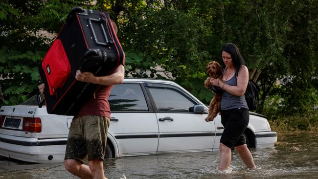 Residents in Kherson flee with what they can carry after the destruction of the Nova Kakhovka dam. Picture: Reuters