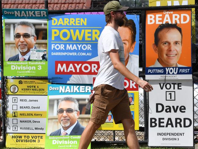 A voter in the Logan City Council election is seen at a pre-polling booth in the suburb of Slacks Creek in Logan City, Thursday, March 26, 2020. Queensland's local government elections are due to be held on Saturday despite the threat of the Coronavirus (COVID-19).  (AAP Image/Darren England) NO ARCHIVING