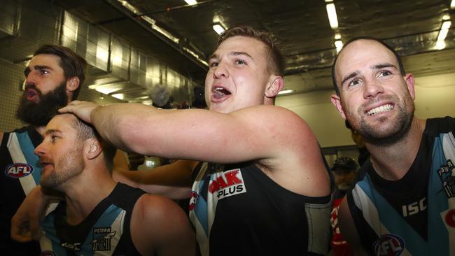 Matthew Broadbent (far right) sings the Power song with ex-teammates Justin Westhoff, Sam Gray and Ollie Wines after a win. Picture: Sarah Reed