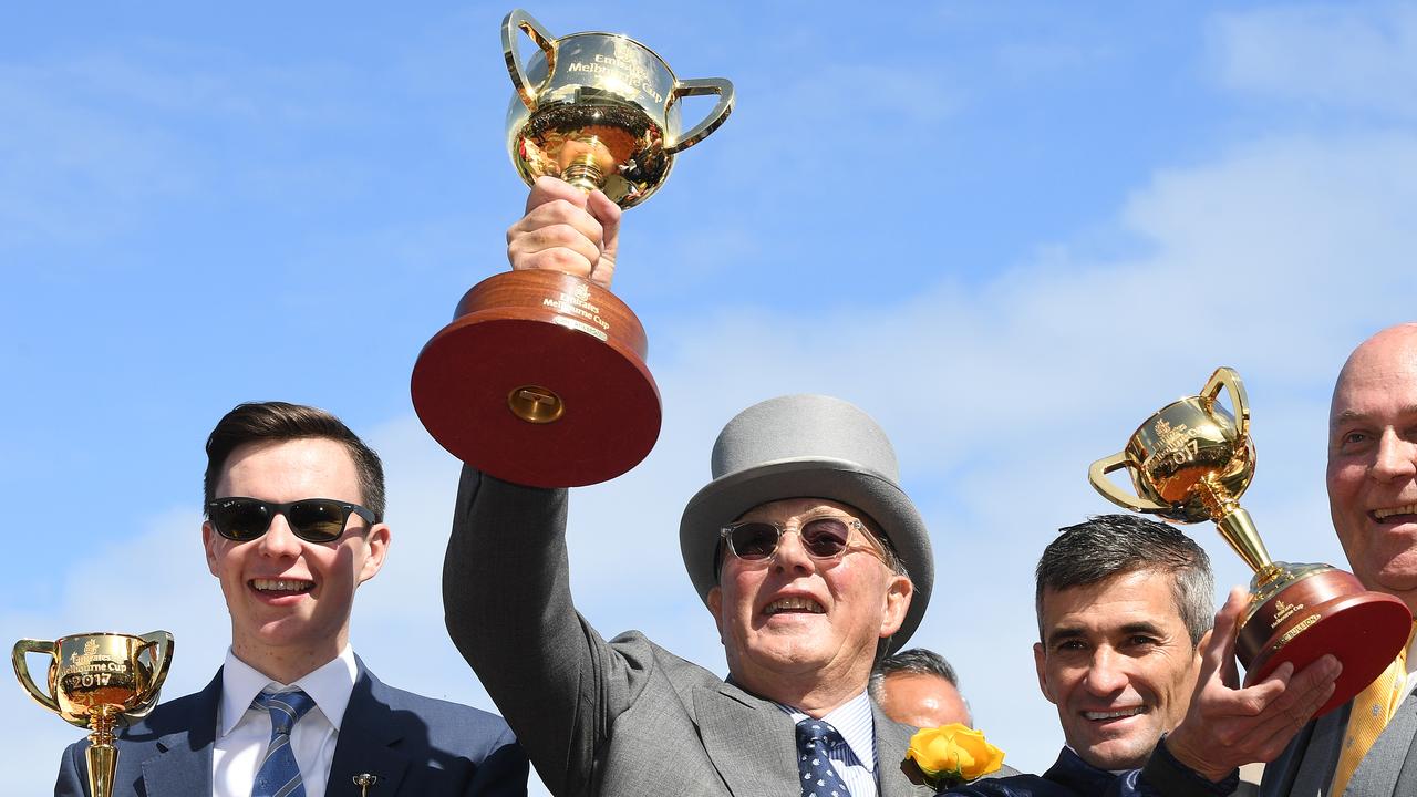 Trainer Joseph O'Brien, part owner Lloyd Williams, jockey Corey Brown are seen holding the respective Melbourne Cup trophies after Rekindling won the 2017 Melbourne Cup. Picture: Julian Smith/AAP