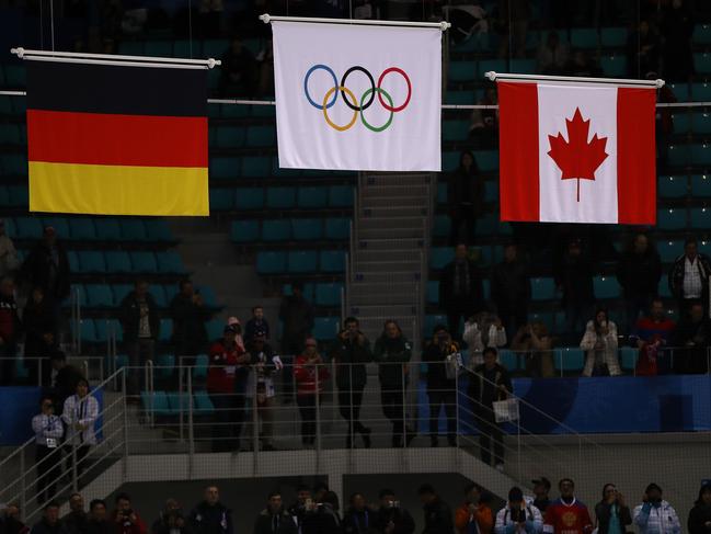 GANGNEUNG, SOUTH KOREA - FEBRUARY 25:  The Olympic flag is raised after gold medal winners Olympic Athletes from Russia defeated Germany 4-3 in overtime during the Men's Gold Medal Game on day sixteen of the PyeongChang 2018 Winter Olympic Games at Gangneung Hockey Centre on February 25, 2018 in Gangneung, South Korea.  (Photo by Ronald Martinez/Getty Images)