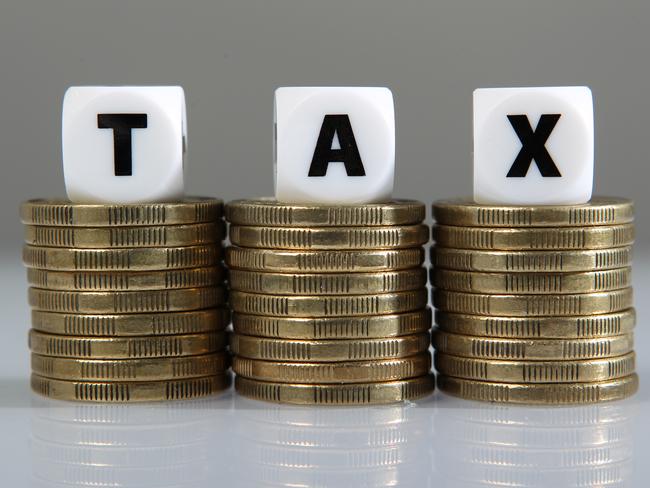 Your Money generic images. Stack of gold one dollar coins and the word tax.