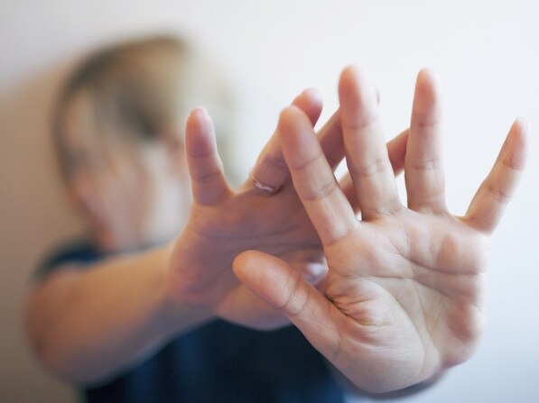 A young woman protects herself by hand Photo: iStock