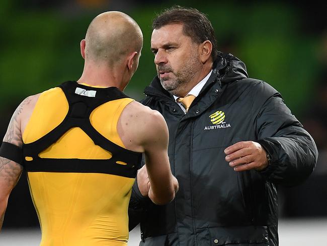 Socceroos coach Ange Postecoglou with midfielder Aaron Mooy after Australia’s World Cup qualifier against Thailand in Melbourne on Tuesday night.