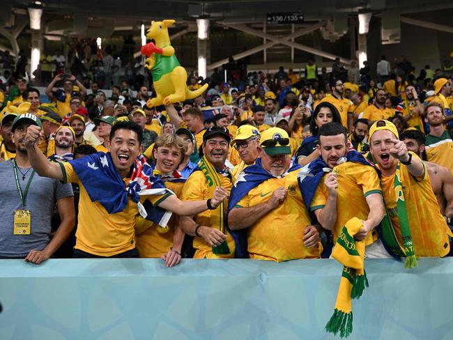 Australia supporters celebrate after their team won the Qatar 2022 World Cup Group D football match between Australia and Denmark at the Al-Janoub Stadium in Al-Wakrah, south of Doha on November 30, 2022. (Photo by Paul ELLIS / AFP)