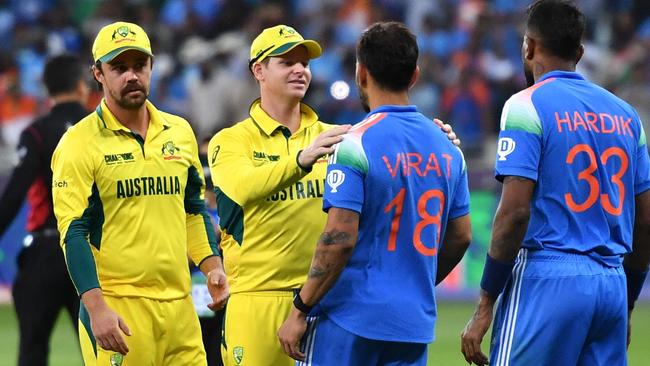 Australia's captain Steve Smith congratulates Virat Kohli. Picture: Ryan Lim / AFP