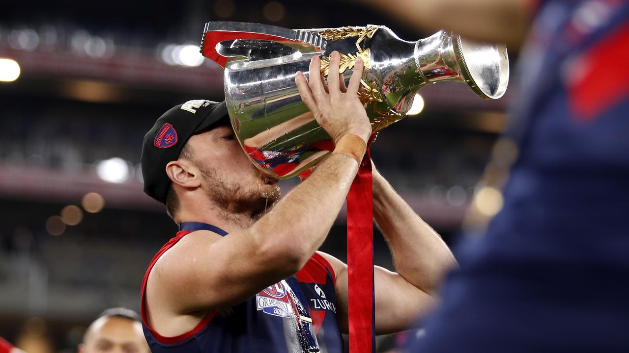 Michael Hibberd of the Demons takes a drink from the premiership cup. Picture: Dylan Burns