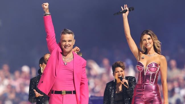 Robbie Williams, seen here alongside Delta Goodrum, earned widespread praise for his grand final performance in 2022. (Photo by Mark Kolbe/AFL Photos/via Getty Images)