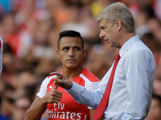 Arsene Wenger gets his point across to new signing Alexis Sanchez.