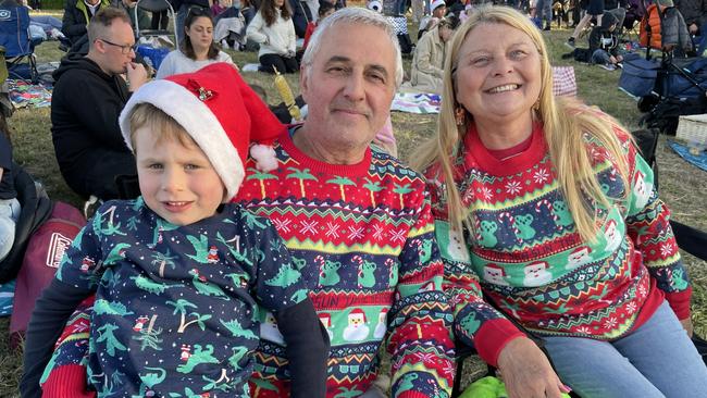 Frankston's Alf and Sue Cleverdog with Odin McKay at Manningham's 2022 Carols.