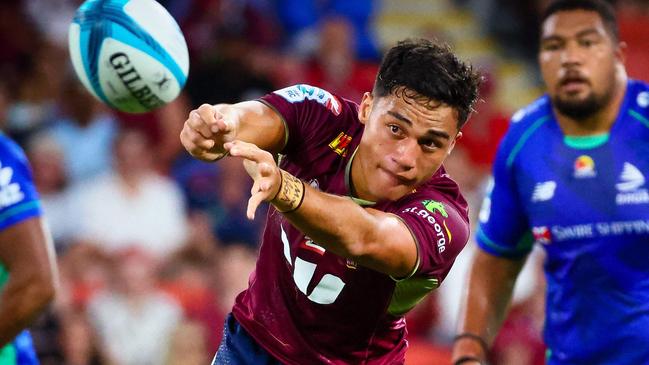 Queensland Red's Kalani Thomas makes a pass during the Super Rugby match between the Queensland Reds and Fijian Drua at Suncorp Stadium in Brisbane on March 12, 2022. (Photo by Patrick HAMILTON / AFP) / -- IMAGE RESTRICTED TO EDITORIAL USE - STRICTLY NO COMMERCIAL USE --