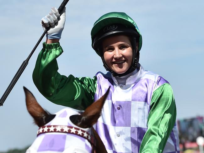 Michelle Payne celebrates as she returns to the mounting yard after she rode Prince of Penzance. Picture: Julian Smith/AAP