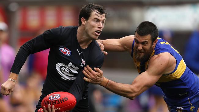 Blue Lachie Plowman does his best to evade Josh Kennedy. Picture: Paul Kane/Getty Images