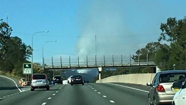 Smoke from the controlled burn at Bonogin was visible to motorists going south on the Pacific Highway this morning. Photo: Dean Shelton/Facebook