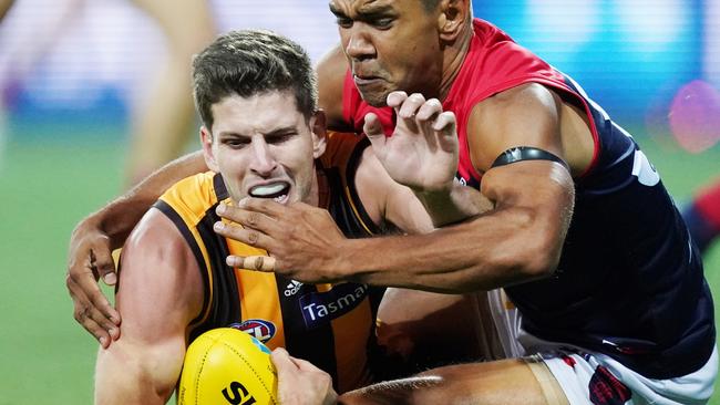 Neville Jetta of the Demons tackle Luke Breust of the Hawks during the AFL Marsh Community Series pre-season match between the Hawthorn Hawks and the Melbourne Demons at UTAS Stadium in Launceston, Friday, March 6, 2020. (AAP Image/Michael Dodge)