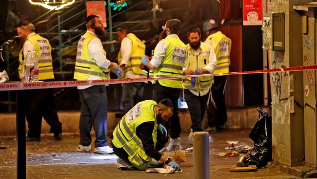 Forensics experts comb the scene of the shooting in Tel Aviv on Thursday. Picture: AFP