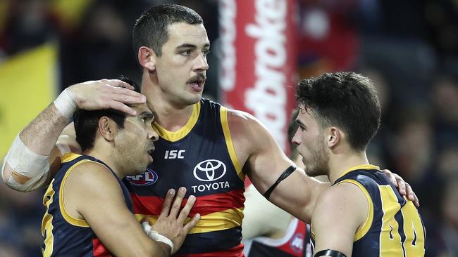 Taylor Walker celebrates a goal with Eddie Betts and Lachie Murphy. Picture: Sarah Reed