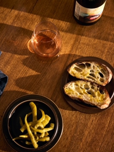 A couple of slices of Templo’s ciabatta drizzled with olive oil and dusted with flaky sea salt with guindilla pickles. Picture: REMI CHAUVIN