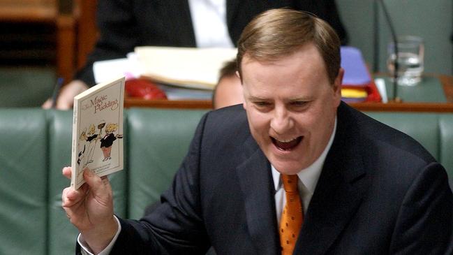 Then Treasurer Peter Costello with The Magic Pudding book in parliament - a narrative Qantas finances now rely on. Picture: AAP Image/Alan Porritt