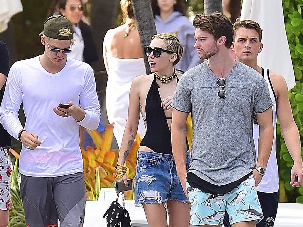 Miley Cyrus, centre, with her then-boyfriend Patrick Schwarzenegger (right) and Cody Simpson (left). Picture: Splash